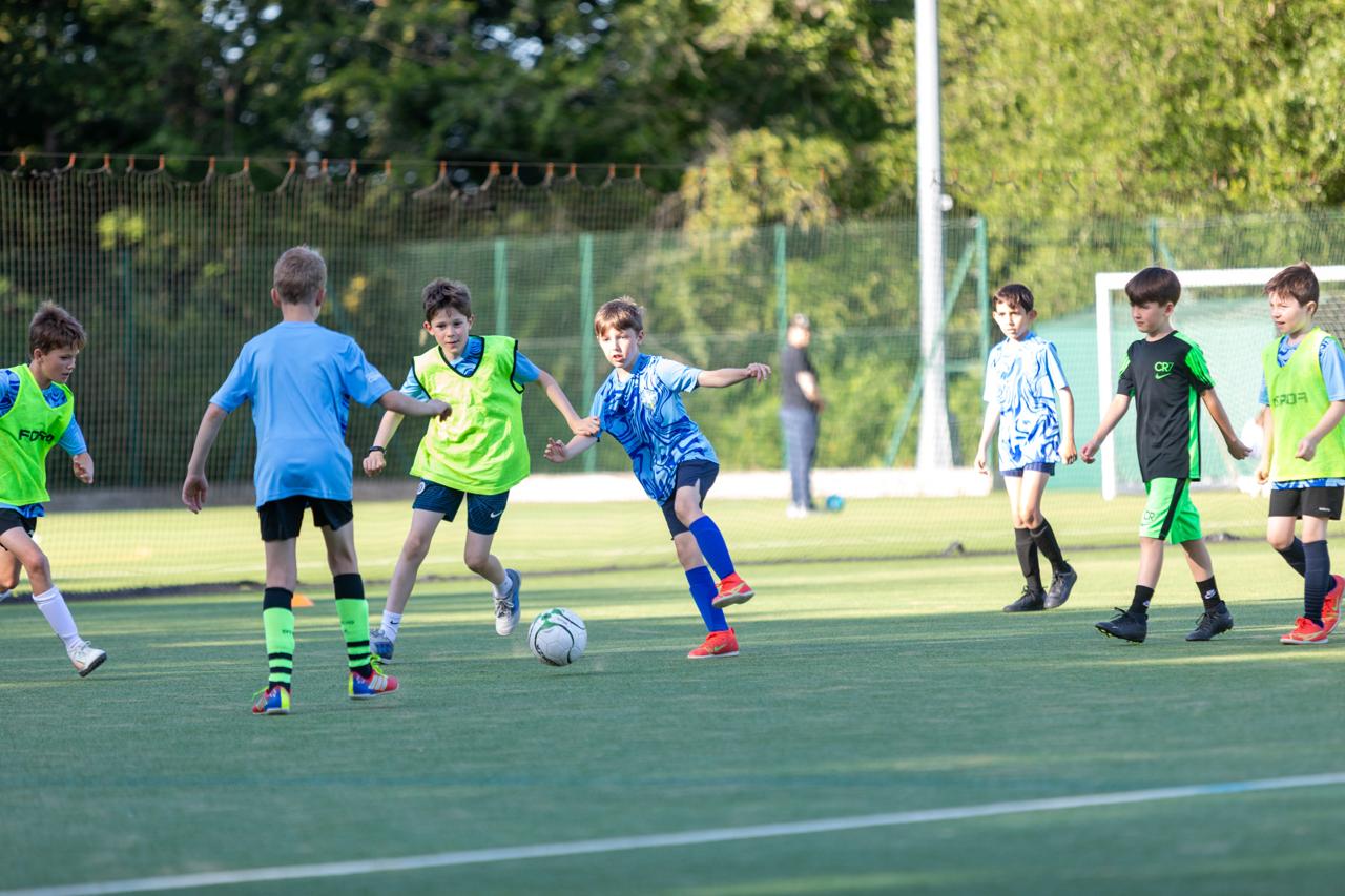 Young Rowledge player driving forward with the ball